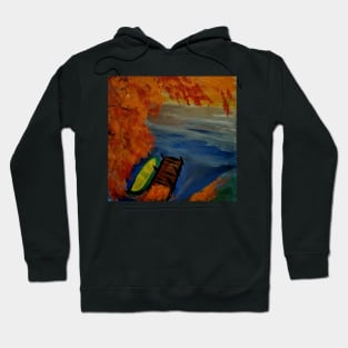 A small boat on a lake Hoodie